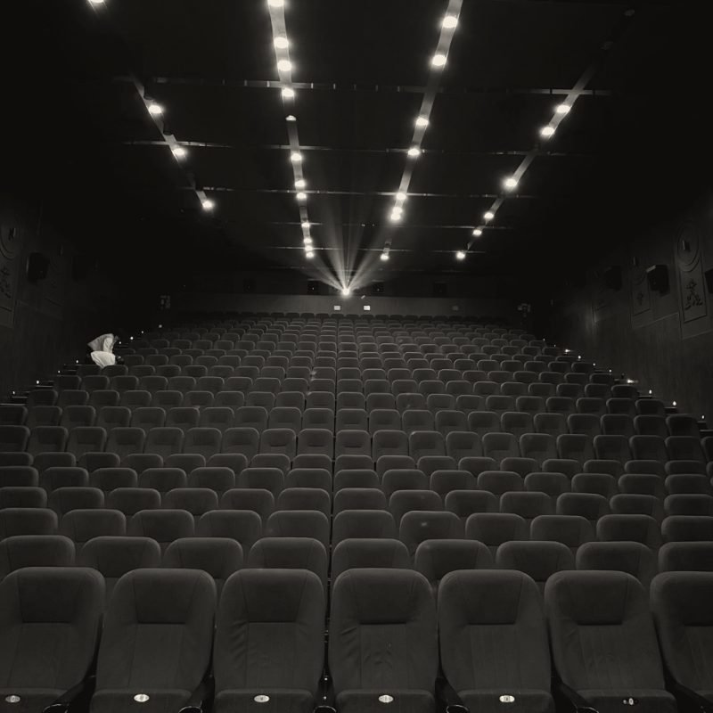 Empty cinema hall with a projector beam