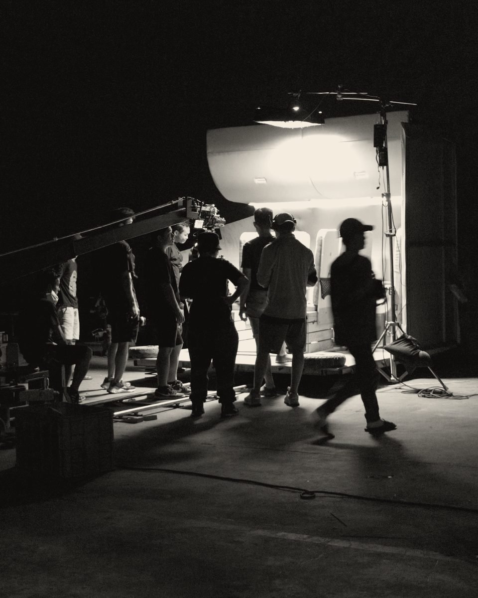 Film crew working on a lit set